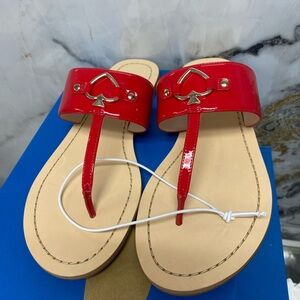 NWOT kate Spade Cassie flat thong sandals. Red leather with silver spade